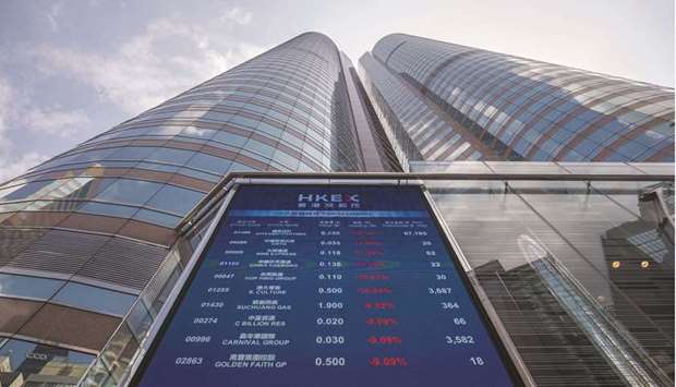 A screen displays stock figures outside the Hong Kong Stock Exchange. The Hang Seng index closed up 1.9% to 30,735.78 points yesterday.
