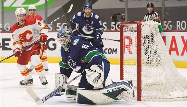 Vancouver Canucks goalie Thatcher Demko makes a save against the Calgary Flames in the third period period of their NHL game at Rogers Arena in Vancouver. (USA TODAY Sports)