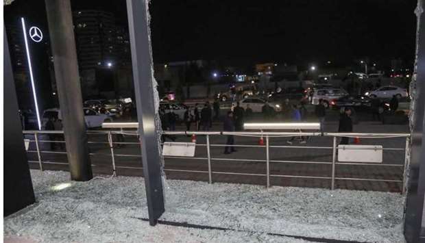 Shattered glass is pictured on the floor of a shop following a rocket attack in Arbil.