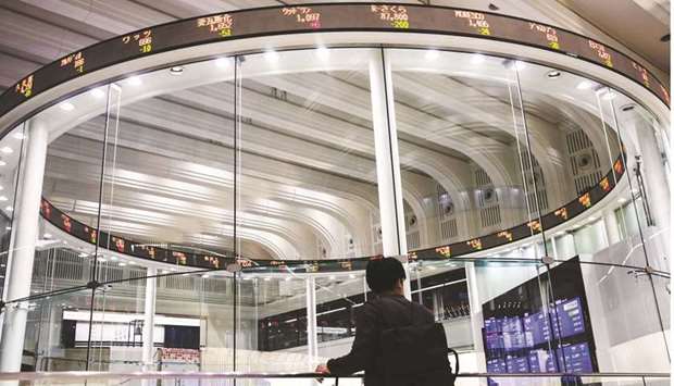 An electronic ticker displays share prices at the Tokyo Stock Exchange. The Nikkei 225 closed down 0.6% to 30,292.19 points yesterday.