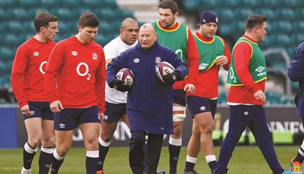 Englandu2019s coach Eddie Jones (centre) walks with his players as they warm up ahead of the Six Nations match against Italy at Twickenham, London, on Saturday. (AFP)