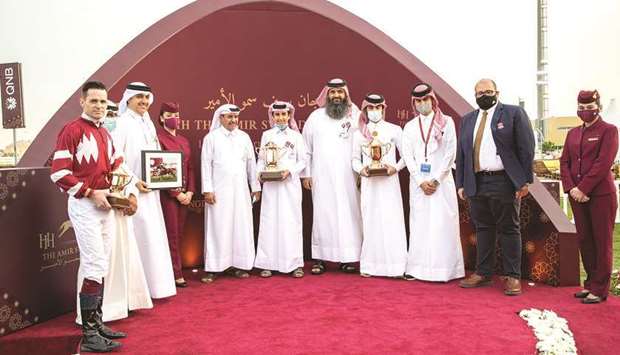 Taleb Meteb al-Saaq (fifth from left) with the winners of the Al Zubara Trophy after Aaley Al Magam won the feature race on the first day of the HH The Amir Sword Festival at Qatar Racing and Equestrian Club's Al Rayyan Park on Thursday. PICTURES: Juhaim