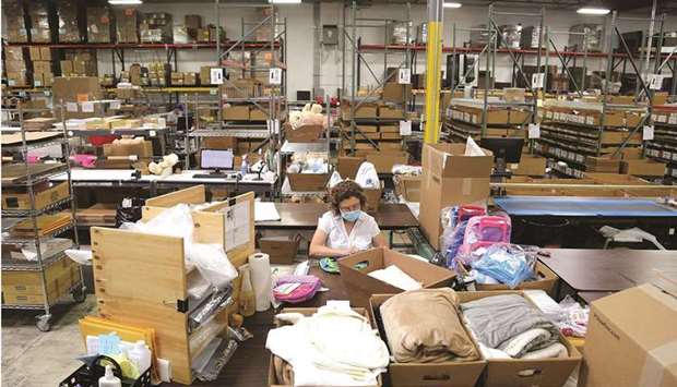 An employee works at the Gifts For You company warehouse in Woodridge, Illinois. At least 18.3mn Americans were receiving unemployment cheques at the end of January, according to the weekly report from the Labour Department yesterday.