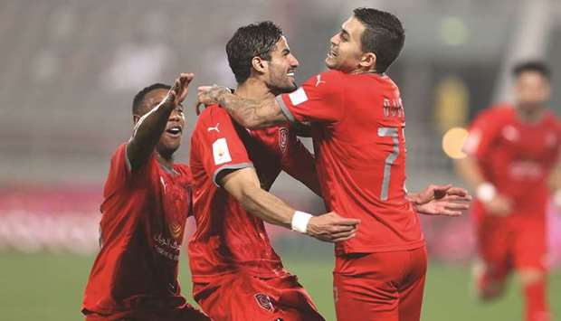 Al Duhail's Sultan al-Braik (centre) celebrates with team-mates after scoring against Al Gharafa.rnr