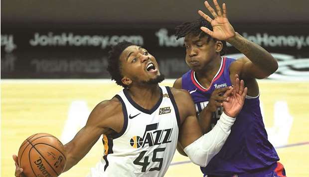 Utah Jazz guard Donovan Mitchell (left) is defended by Los Angeles Clippers guard Terance Mann as he drives to the basket in the second half of the NBA game at Staples Center in Los Angeles. (USA TODAY Sports)