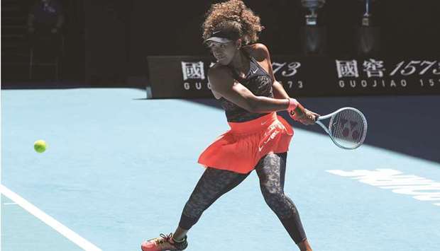 Japanu2019s Naomi Osaka hits a return against Serena Williams of the US during their  semi-final match on day eleven of the Australian Open yesterday.