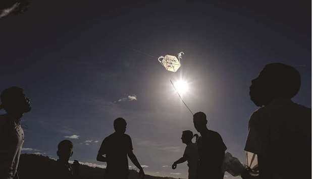 Children fly a kite during the commemoration of the 400th anniversary of the Petare neighbourhood in Caracas.