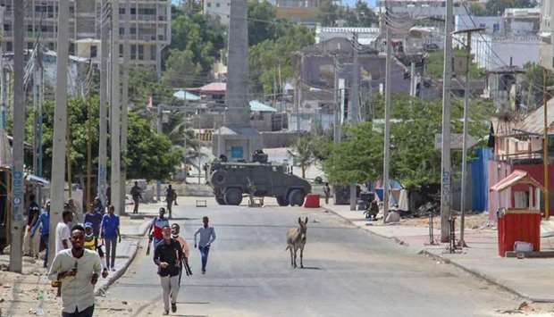 Men flee the site of violent clashes in the Somalian capital, Mogadishu