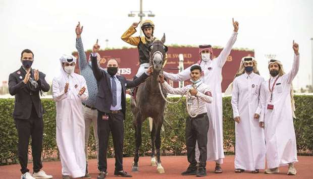 Trainer Wasim al-Sahn (fourth from left) and connections celebrate in the winner's enclosure after Ghannam, with Alberto Sanna (centre) astride, won the Gulf Cup on Friday.