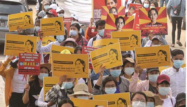 Protesters march with signs demanding the release of detained Myanmar leader Aung San Suu Kyi during a demonstration against the military coup in Naypyidaw.
