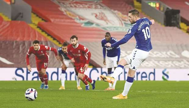Evertonu2019s Gylfi Sigurdsson scores their second goal from the penalty spot during their Premier League match against Liverpool yesterday. (Reuters)
