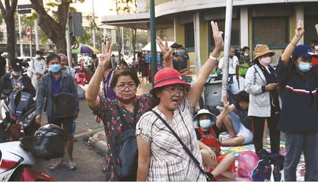 Pro-democracy protesters hold up the three finger salute during an anti-government rally in Bangkok.