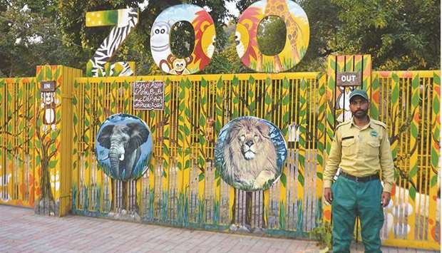 This picture taken on January 6 shows a wildlife ranger in front of the entrance to the closed Marghazar Zoo, located in the Margalla Hill National Park in Islamabad.