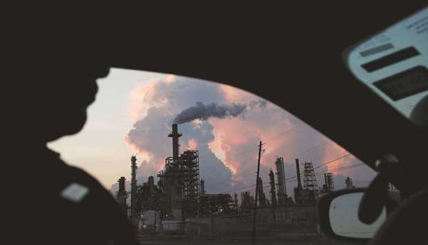 A police officer drives past a refinery in the industrial east end in Pasadena, Texas (file). Filings submitted in recent days to the Texas Commission on Environmental Quality, or TCEQ, already show significant emissions related to stopping and restarting fossil fuel infrastructure. Itu2019s an indication of whatu2019s to come in a state thatu2019s home to a quarter of US natural gas production as well as half the oil production.