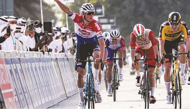 Mathieu van der Poel (left) of Team Alpecinu2013Fenix gestures as he approaches the finish line to win the first stage of the UAE Cycling Tour yesterday. (AFP)