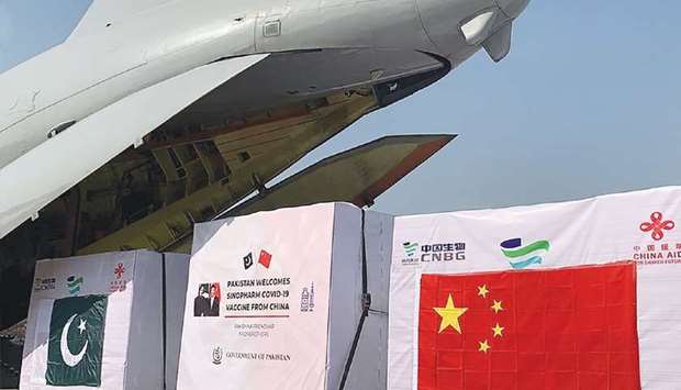 This handout picture released by the Pakistan health ministry shows the first batch of Covid-19 vaccine boxes unloaded from a Pakistan air force plane after arriving from China, at the Nur Khan military airbase in Islamabad.