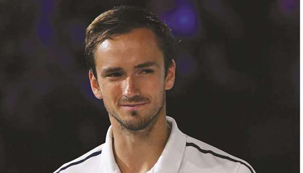 Russiau2019s Daniil Medvedev holds his runners-up trophy after losing against Serbiau2019s Novak Djokovic in their Australian Open final match yesterday in Melbourne.
