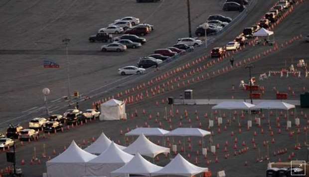 Vehicles line up at Dodger Stadium Covid-19 vaccination site at sunset during the outbreak of the coronavirus disease, in Los Angeles, California on February 1, 2021. REUTERS