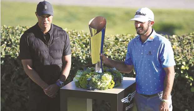 Max Homa (right) of the United States stands with the trophy and tournament host Tiger Woods after winning the The Genesis Invitational in a playoff at Riviera Country Club in Pacific Palisades, California, United States, on Sunday. (AFP)