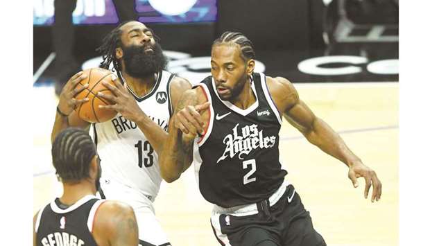 Brooklyn Nets guard James Harden is defended by Los Angeles Clippers forward Kawhi Leonard (right) as he drives to the basket in the first-half of the NBA game at Staples Center. (USA TODAY Sports)