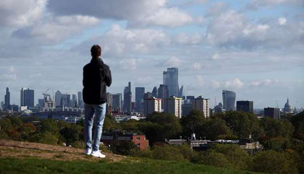 A person looks at the skyline of central London in the background, amid the outbreak of the coronavirus disease (Covid-19), in London, Britain