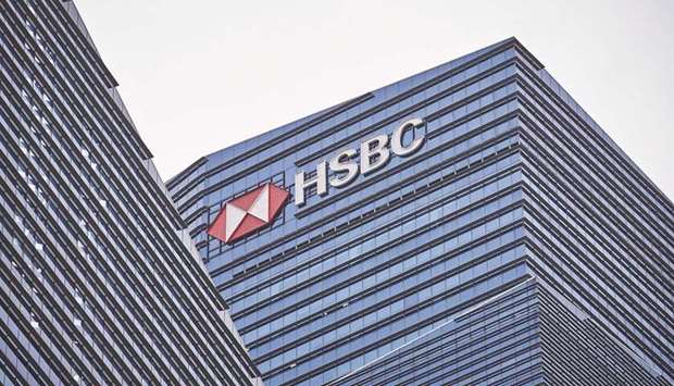 Signage for HSBC Holdings is displayed on the building that houses its headquarters in the central business district of Singapore. HSBC will shift billions of dollars of investment to Asiau2019s faster growing economies as it looks to become the go-to bank for the regionu2019s wealthy.