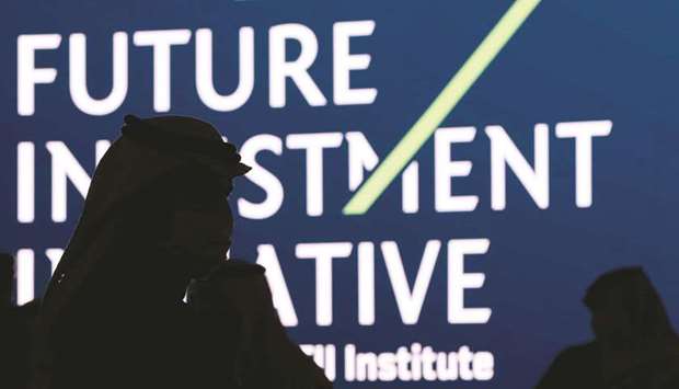 Silhouettes of Saudi men are seen during the opening ceremony of the fourth annual Future Investment Initiative in Riyadh on January 27. The kingdom is working on creating a consolidated balance sheet of its assets and liabilities, which will include items currently kept off the oil-rich economyu2019s books, including the investments and debts of its sovereign wealth fund.