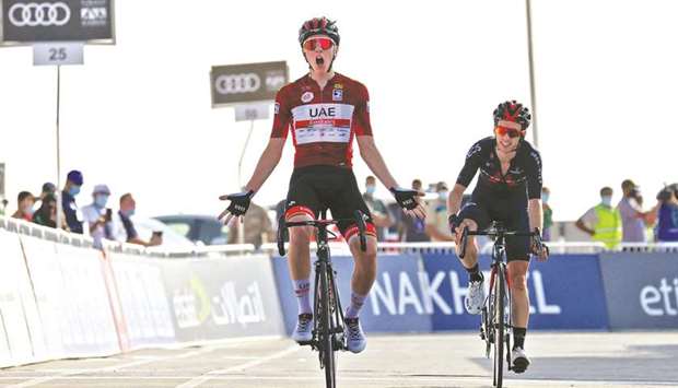 UAE Team Emiratesu2019 Slovenian cyclist Tadej Pogacar celebrates upon crossing the finish line to win the third stage of the UAE Cycling Tour from Al Ain to Jebel Hafeet yesterday. (AFP)