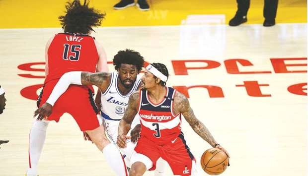 Washington Wizards guard Bradley Beal moves the ball as center Robin Lopez provides coverage against Los Angeles Lakers guard Wesley Matthews during the second half of their NBA game at Staples Center in Los Angeles. (USA TODAY Sports)