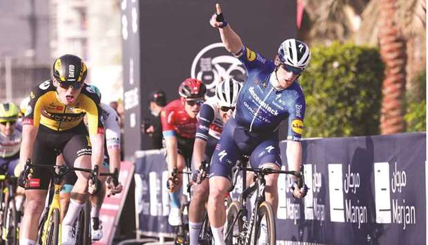 Sam Bennett (right) of Deceuninck Quick Step team celebrates after crossing the finish line of the fourth stage of the UAE Tour at al-Marjan Island yesterday. (AFP)