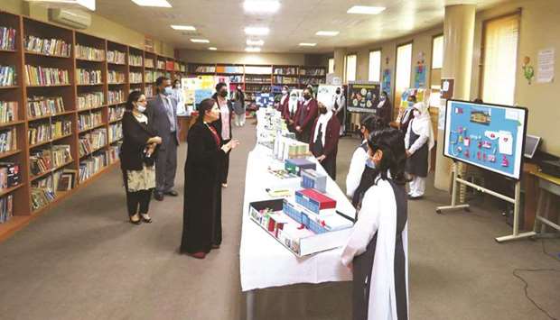 School officials tour the exhibition.