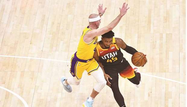 Donovan Mitchell (right) of the Utah Jazz drives into Alex Caruso of the Los Angeles Lakers during their game at Vivint Smart Home Arena in Salt Lake City, Utah. (Getty Images/AFP)