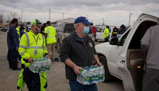Volunteers give water to residents affected by unprecedented winter storm in Houston, Texas