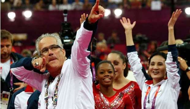 In this file photo taken on July 31, 2012, US women gymnastics team's coach John Geddert celebrates with the rest of the team after the US won gold in the women's team artistic gymnastics event at the London Olympic Games