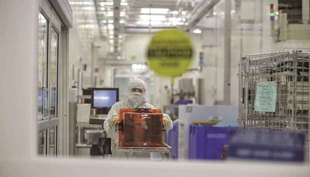 A technician pushes a cart of semiconductor wafers at the Applied Materials facility in Santa Clara, California. u201cIu2019m directing senior officials in my administration to work with industrial leaders to identify solutions to the semiconductor shortfall,u201d US President Joe Biden said.