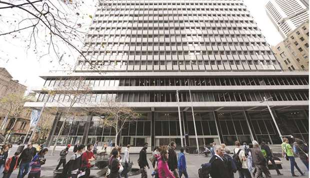 Pedestrians walk past the Reserve Bank of Australia headquarters in the central business district of Sydney. The RBA bought $4bn of bonds, matching the record last March when it began quantitative easing.