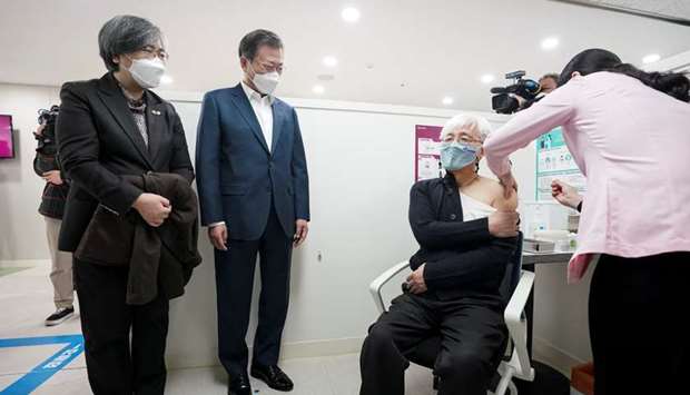South Korean President Moon Jae-in, watches a doctor receives a shot of AstraZeneca vaccine at a public health center in Seoul