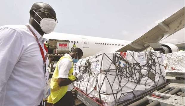 Workers unload a shipment of AstraZeneca Covid-19 vaccine bearing Covax stickers from a plane at Felix Houphouet Boigny airport of Abidjan, yesterday.