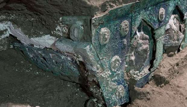 A photo handout by the archaeological park of Pompeii shows a detail of a large Roman four-wheeled ceremonial chariot after it was discovered near the The archaeological park of Pompeii