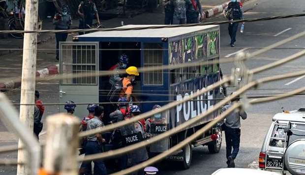 Police arrest people as they crack down on demonstrations by protesters against the military coup in Yangon