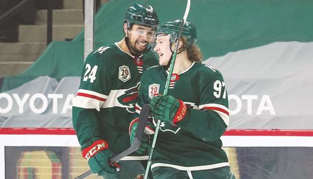 Minnesota Wild defenseman Matt Dumba (left) celebrates with left wing Kirill Kaprizov after Kaprizov scored a goal against the Los Angeles Kings in the first period at Xcel Energy Center. (USA TODAY Sports)