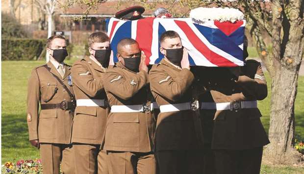 The coffin is carried by members of the Armed Forces during the funeral service of Captain Moore at Bedford Crematorium.