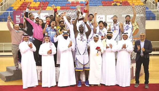 Al Gharafa players and officials celebrate after winning the Qatar Cup yesterday.