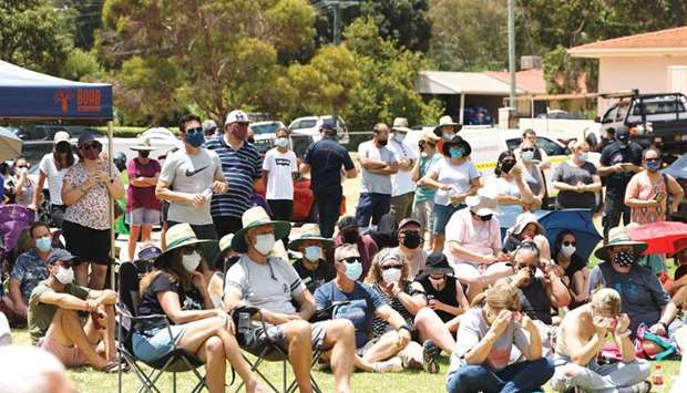 Residents wait to hear a briefing at an evacuation centre in the suburb of Swan View in Perth, where they sought shelter from fires that have claimed over seventy homes.