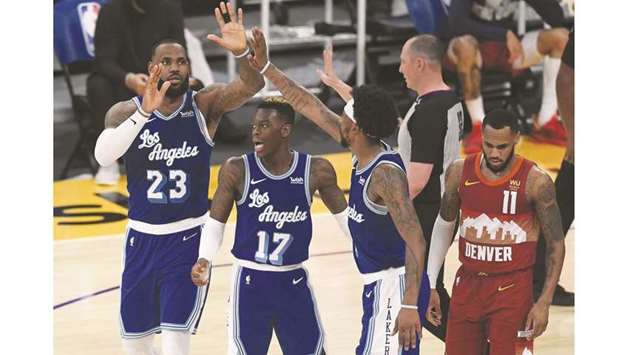 LeBron James (left) of the Los Angeles Lakers celebrates his basket with Dennis Schroder (second left) and Kentavious Caldwell-Pope (second right) 1 against the Denver Nuggets at Staples Center in Los Angeles. (Getty Images/AFP)