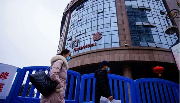 People walk past the Wuhan Central Hospital in Wuhan, in Hubei province, China