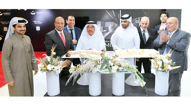 Nabina Holding chairman Abdulaziz Mohamed Nabina leads the cake-cutting ceremony with CEO Tariq Abdulaziz Nabina looking on during the 70th anniversary celebration of the company recently. PICTURES: Feroze Ahamed