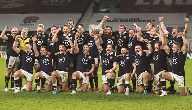 Scotland players pose with the Calcutta Cup after their win over England in the Six Nations Championship in London yesterday. (Reuters)