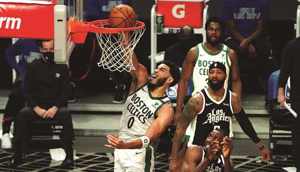 Boston Celtics forward Jayson Tatum (left) dunks the ball over LA Clippers center Serge Ibaka (9) in the second quarter at Staples Center. Mandatory Credit: Kirby Lee-USA TODAY Sports