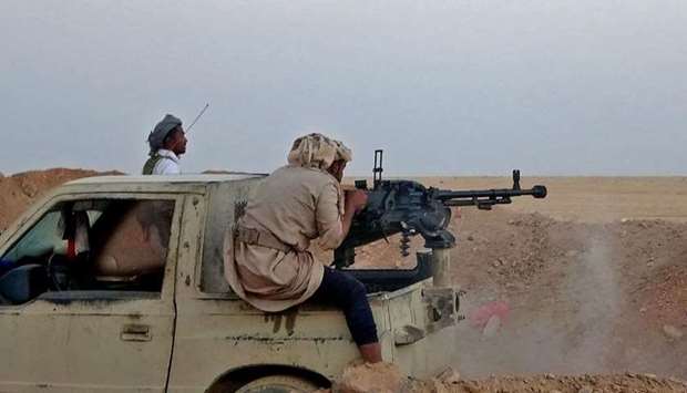 In this file photo taken on November 22, 2020 a combatant mans a heavy machine gun as forces loyal to Yemen's government clash with Houthi rebel fighters around the strategic government-held ,Mas Camp, military base, in al-Jadaan area about 50 kilometres northwest of Marib in central Yemen.